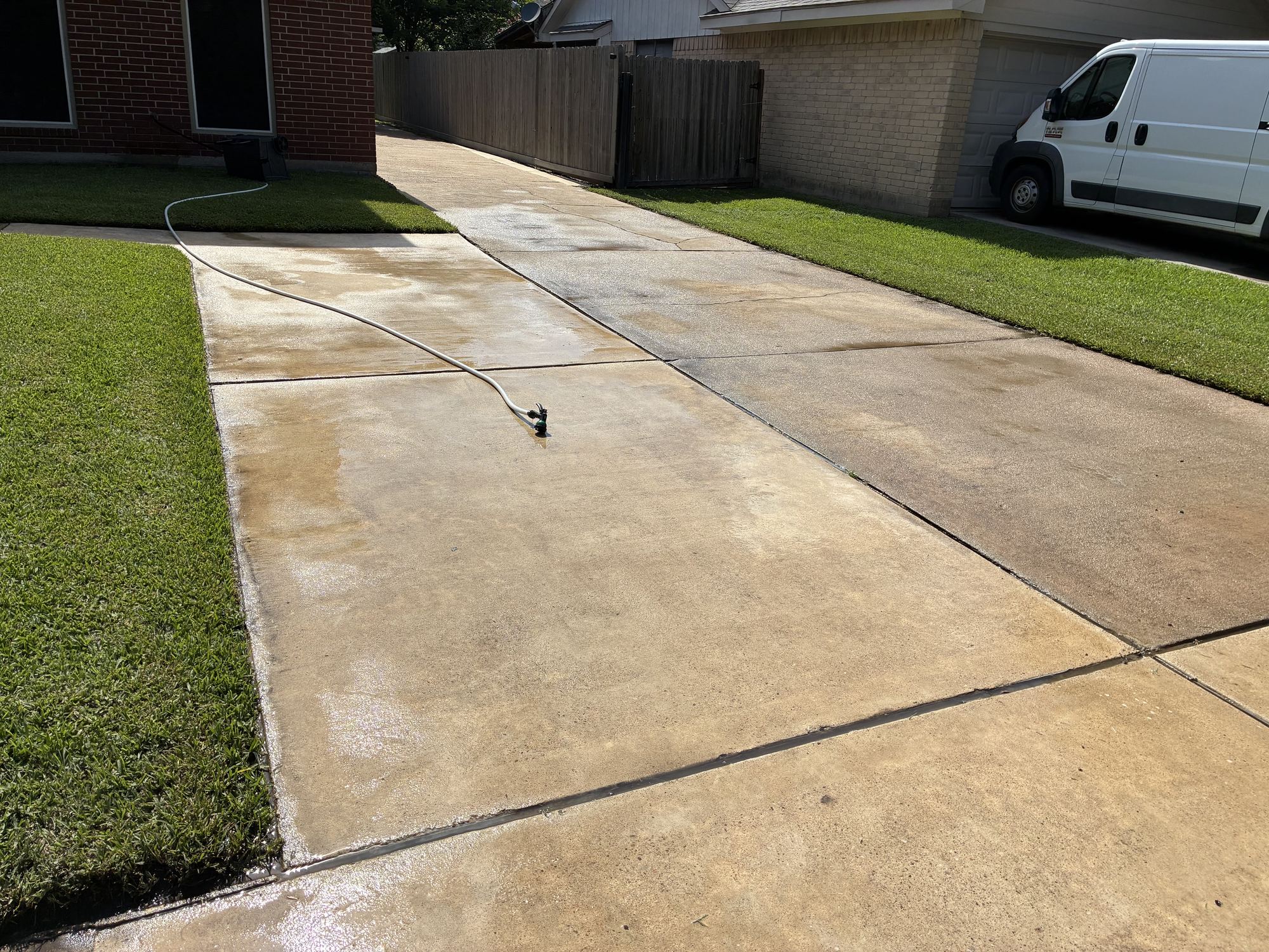 Freshly pressure washed Houston driveway, still glistening